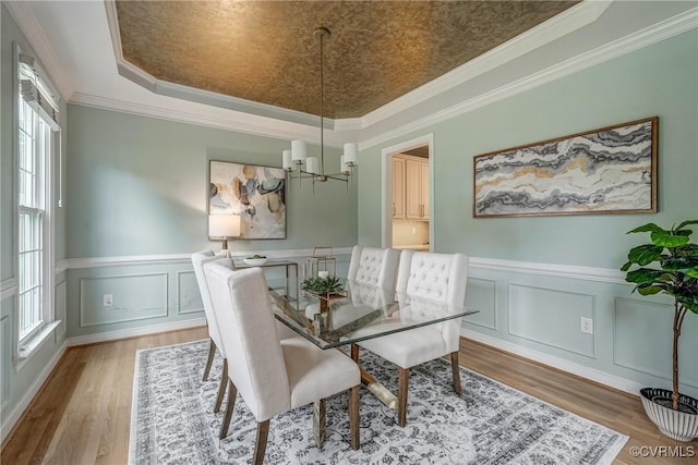 3731 Rivermist Ter, Midlothian, VA 23113 - dining room with a raised ceiling, wood finished floors, a chandelier, ornamental molding, and wainscoting