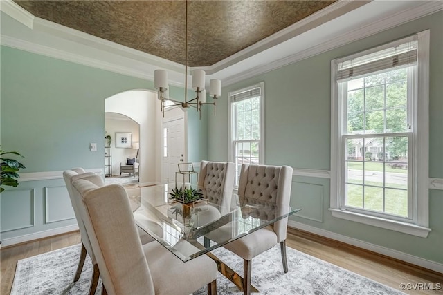 3731 Rivermist Ter, Midlothian, VA 23113 - dining space with arched walkways, a chandelier, plenty of natural light, wood finished floors, and wainscoting
