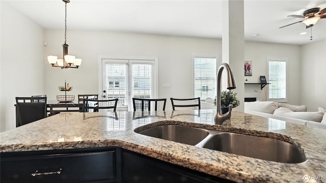 3809 Crows Nest Ct, Hopewell, VA 23860 - kitchen with light stone counters, a chandelier, open floor plan, decorative light fixtures, and a ceiling fan