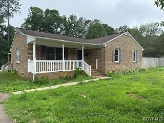 12123 Spring Run Dr, Amelia Courthouse, VA 23002 - view of front of home featuring a porch, a front lawn, and brick siding