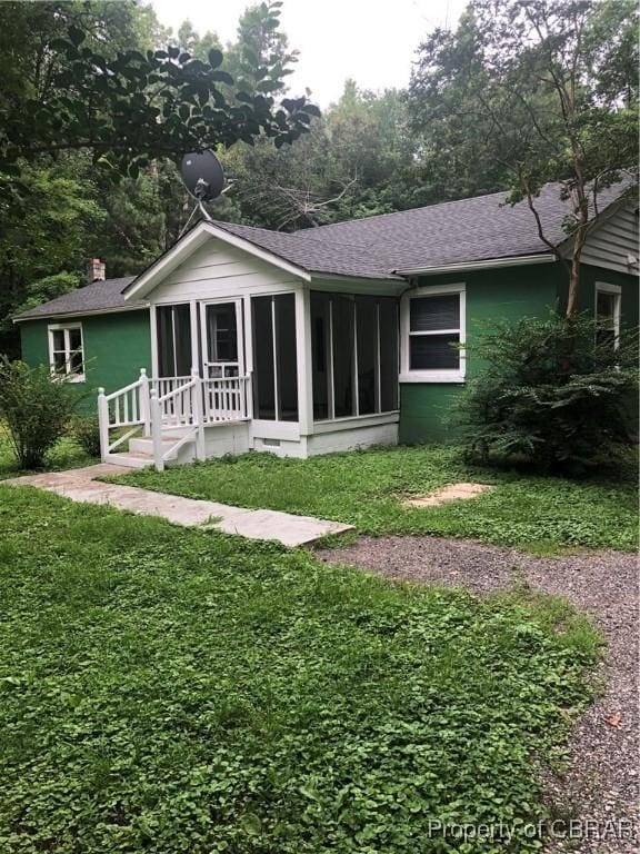271 Bendall Ln, Mathews, VA 23109 - back of property featuring a sunroom, a shingled roof, a lawn, and a chimney