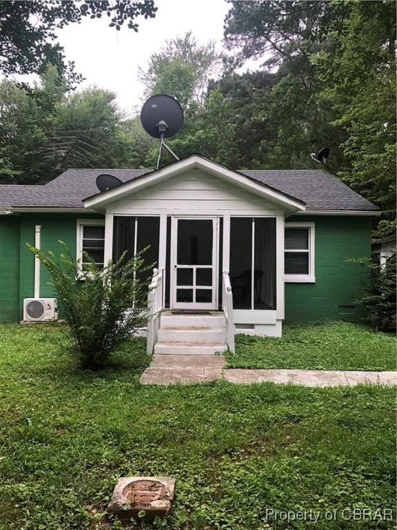 271 Bendall Ln, Mathews, VA 23109 - back of property with a shingled roof, entry steps, a sunroom, a lawn, and concrete block siding