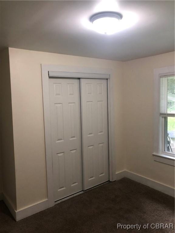 271 Bendall Ln, Mathews, VA 23109 - unfurnished bedroom with dark carpet and a closet