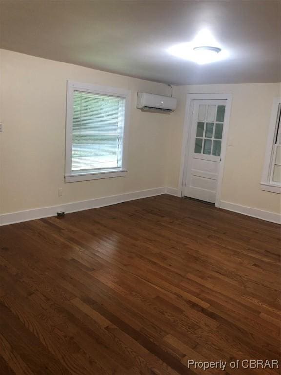 271 Bendall Ln, Mathews, VA 23109 - unfurnished room featuring a wall mounted AC and dark wood-type flooring