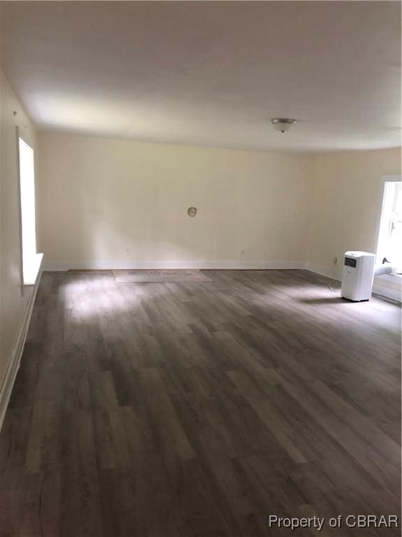 271 Bendall Ln, Mathews, VA 23109 - unfurnished living room with dark wood-style floors and baseboards