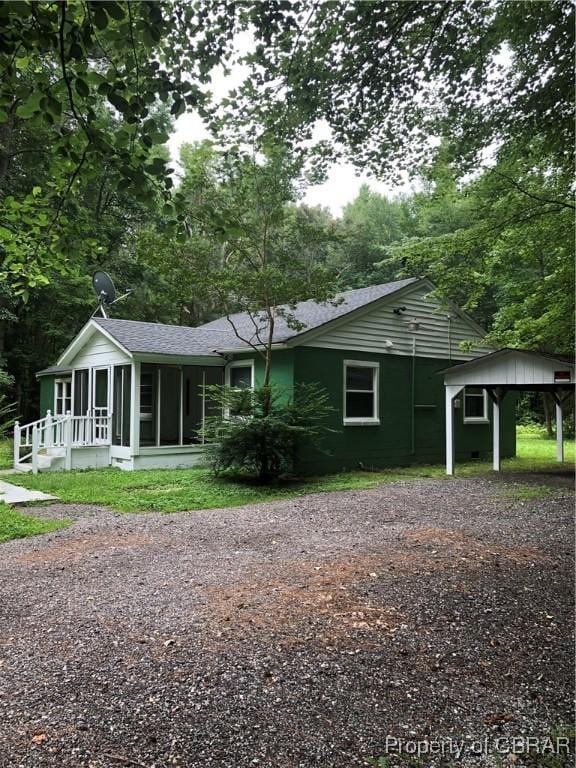 271 Bendall Ln, Mathews, VA 23109 - view of front of property featuring a sunroom, driveway, a shingled roof, and a detached carport