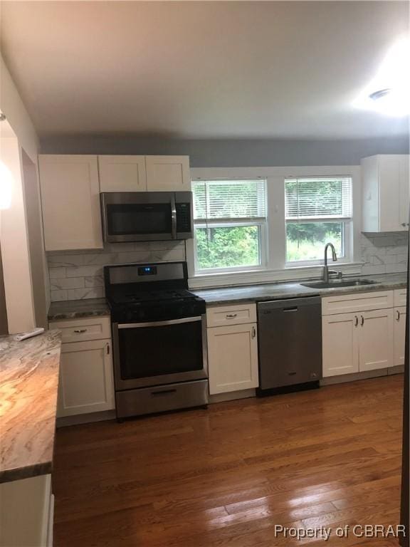 271 Bendall Ln, Mathews, VA 23109 - kitchen with appliances with stainless steel finishes, white cabinetry, and decorative backsplash