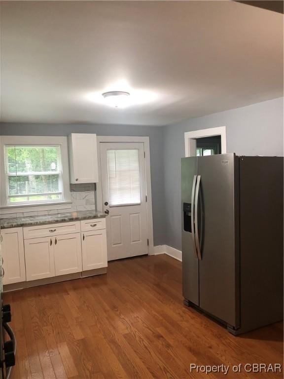 271 Bendall Ln, Mathews, VA 23109 - kitchen featuring stainless steel fridge, white cabinets, dark wood-type flooring, backsplash, and dark stone counters