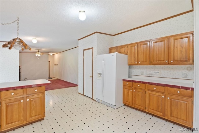 4867 Tabscott Rd, Kents Store, VA 23084 - kitchen with white refrigerator with ice dispenser, wallpapered walls, crown molding, tile countertops, and a ceiling fan