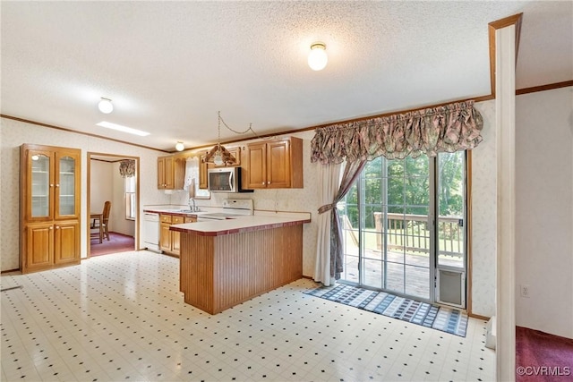 4867 Tabscott Rd, Kents Store, VA 23084 - kitchen featuring ornamental molding, white appliances, light countertops, a peninsula, and a textured ceiling
