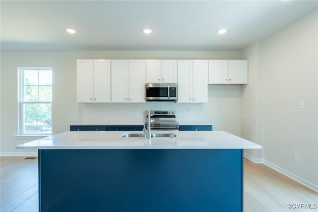14631 Hancock Towns Dr Unit N6, Chesterfield, VA 23832 - kitchen with appliances with stainless steel finishes, light wood-type flooring, white cabinetry, a kitchen island with sink, and light countertops