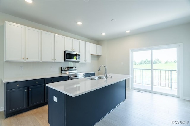 14631 Hancock Towns Dr Unit N6, Chesterfield, VA 23832 - kitchen featuring stainless steel appliances, light wood-type flooring, white cabinets, an island with sink, and light countertops