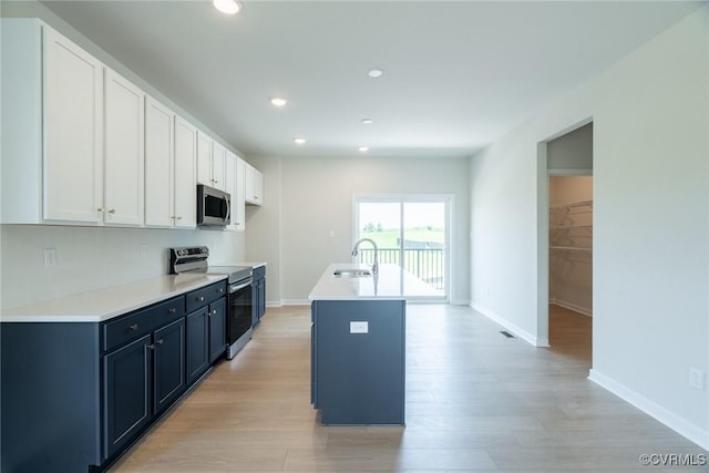 14631 Hancock Towns Dr Unit N6, Chesterfield, VA 23832 - kitchen featuring appliances with stainless steel finishes, white cabinetry, light wood finished floors, recessed lighting, and a kitchen island with sink