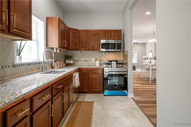 2502 4th Ave, Richmond, VA 23222 - kitchen with stainless steel appliances, light stone countertops, decorative backsplash, recessed lighting, and light tile patterned floors