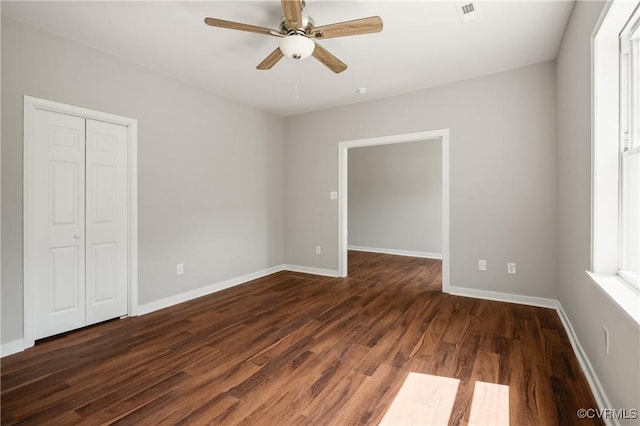 2502 4th Ave, Richmond, VA 23222 - unfurnished bedroom with dark wood-style floors, a closet, and a ceiling fan