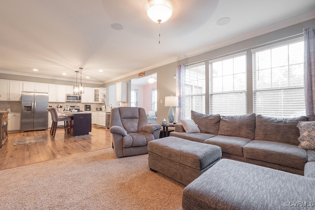 9545 Thornecrest Dr, Mechanicsville, VA 23116 - living room featuring crown molding, light wood finished floors, recessed lighting, light colored carpet, and a chandelier