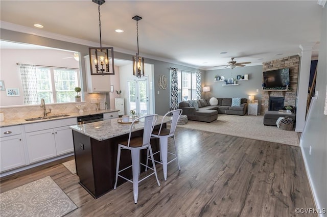 9545 Thornecrest Dr, Mechanicsville, VA 23116 - kitchen featuring a ceiling fan, white cabinets, a stone fireplace, crown molding, and recessed lighting