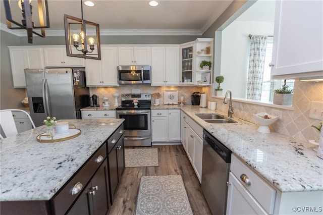 9545 Thornecrest Dr, Mechanicsville, VA 23116 - kitchen with appliances with stainless steel finishes, white cabinetry, dark wood finished floors, ornamental molding, and recessed lighting