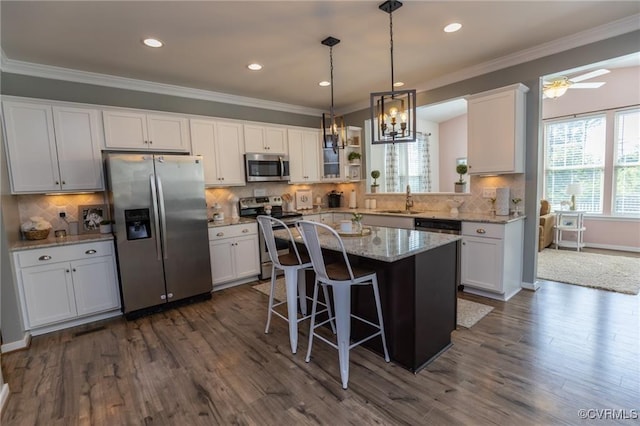 9545 Thornecrest Dr, Mechanicsville, VA 23116 - kitchen featuring appliances with stainless steel finishes, white cabinetry, tasteful backsplash, dark wood-type flooring, and ornamental molding