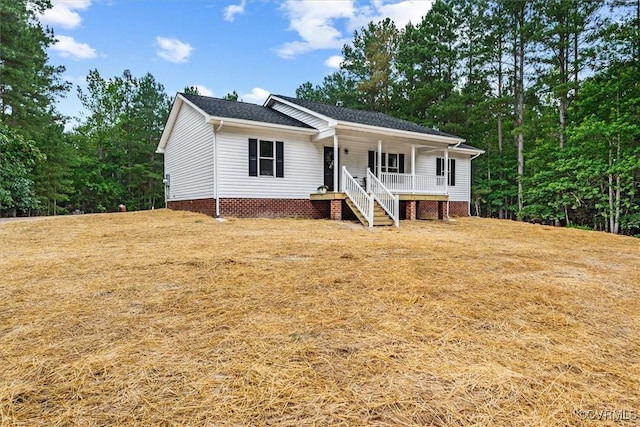 487 Deep Landing Rd, Tappahannock, VA 22560 - view of front facade featuring a porch, a shingled roof, and stairway