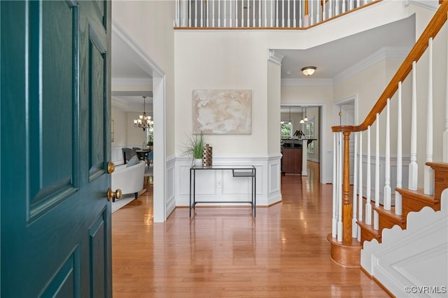 4313 Nevil Bend Turn, Moseley, VA 23120 - foyer featuring stairway, crown molding, a chandelier, light wood-style flooring, and a towering ceiling