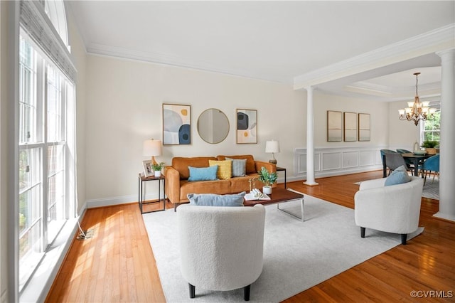 4313 Nevil Bend Turn, Moseley, VA 23120 - living area with decorative columns, crown molding, light wood finished floors, and a chandelier