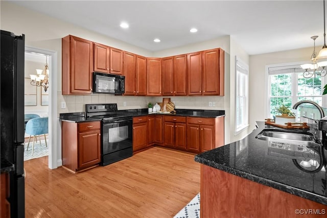 4313 Nevil Bend Turn, Moseley, VA 23120 - kitchen featuring black appliances, a chandelier, light wood-style flooring, decorative backsplash, and recessed lighting