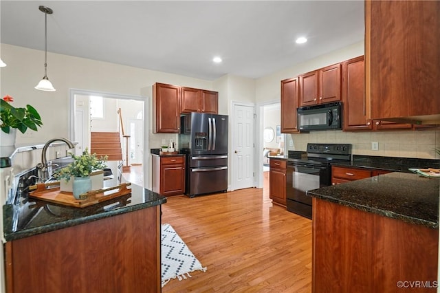 4313 Nevil Bend Turn, Moseley, VA 23120 - kitchen with black appliances, light wood-type flooring, tasteful backsplash, decorative light fixtures, and dark stone countertops