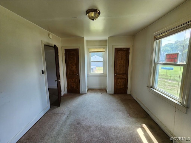 25521 Ferndale Rd, Petersburg, VA 23803 - unfurnished bedroom featuring multiple windows and light colored carpet