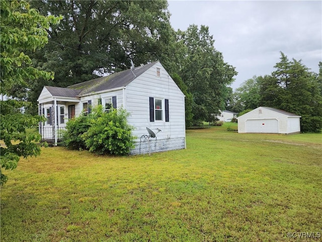 25521 Ferndale Rd, Petersburg, VA 23803 - view of property exterior with a detached garage, an outdoor structure, and a yard