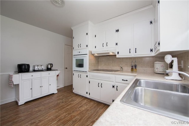 916 Forestview Dr, Colonial Heights, VA 23834 - kitchen with white oven, under cabinet range hood, black electric stovetop, and white cabinetry