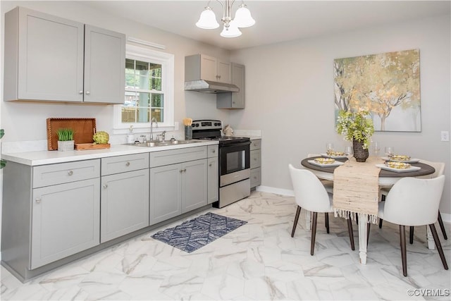 7856 Epic Rd, Midlothian, VA 23235 - kitchen with stainless steel range with electric cooktop, gray cabinets, a chandelier, light marble finish flooring, and under cabinet range hood