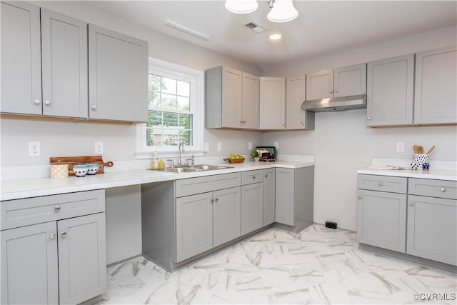 7856 Epic Rd, Midlothian, VA 23235 - kitchen with gray cabinetry, under cabinet range hood, light marble finish floors, recessed lighting, and light countertops