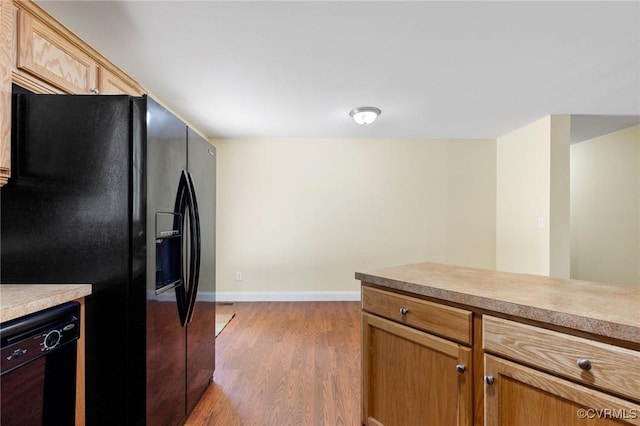 3899 Howell Rd, Powhatan, VA 23139 - kitchen featuring black appliances, wood finished floors, and light countertops