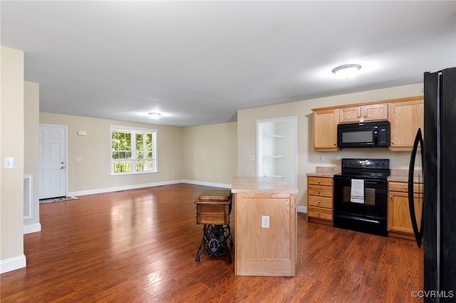 3899 Howell Rd, Powhatan, VA 23139 - kitchen featuring black appliances, dark wood-type flooring, light countertops, and light brown cabinets