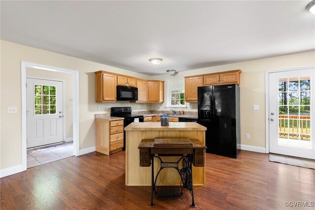 3899 Howell Rd, Powhatan, VA 23139 - kitchen featuring black appliances, a kitchen island, light countertops, and healthy amount of natural light