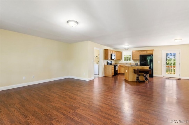 3899 Howell Rd, Powhatan, VA 23139 - unfurnished living room with washer / dryer and dark wood-type flooring