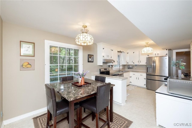 3949 Llewellyn Ln, Chesterfield, VA 23832 - kitchen with stainless steel appliances, a chandelier, white cabinets, and pendant lighting