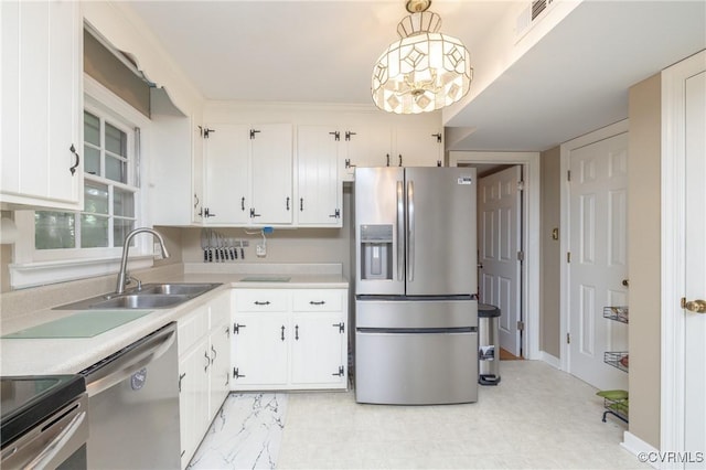 3949 Llewellyn Ln, Chesterfield, VA 23832 - kitchen with stainless steel appliances, light countertops, white cabinetry, and hanging light fixtures