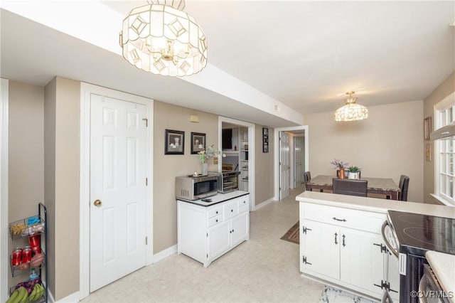 3949 Llewellyn Ln, Chesterfield, VA 23832 - kitchen featuring stainless steel appliances, light flooring, a chandelier, white cabinets, and decorative light fixtures