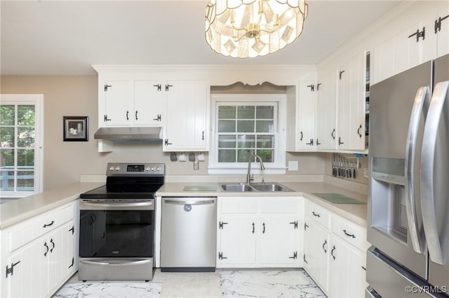 3949 Llewellyn Ln, Chesterfield, VA 23832 - kitchen with stainless steel appliances, under cabinet range hood, light marble finish floors, light countertops, and a chandelier