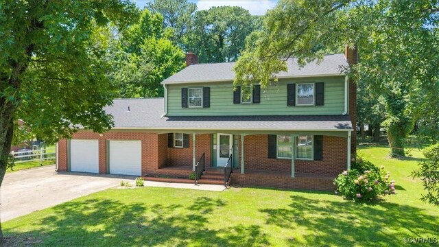 43 Franktown Rd, Hampton, VA 23663 - traditional home with a chimney, an attached garage, concrete driveway, and a front lawn