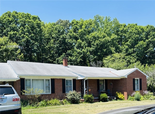 3246 Tabscott Rd, Goochland, VA 23038 - ranch-style house with brick siding, a front yard, and a chimney