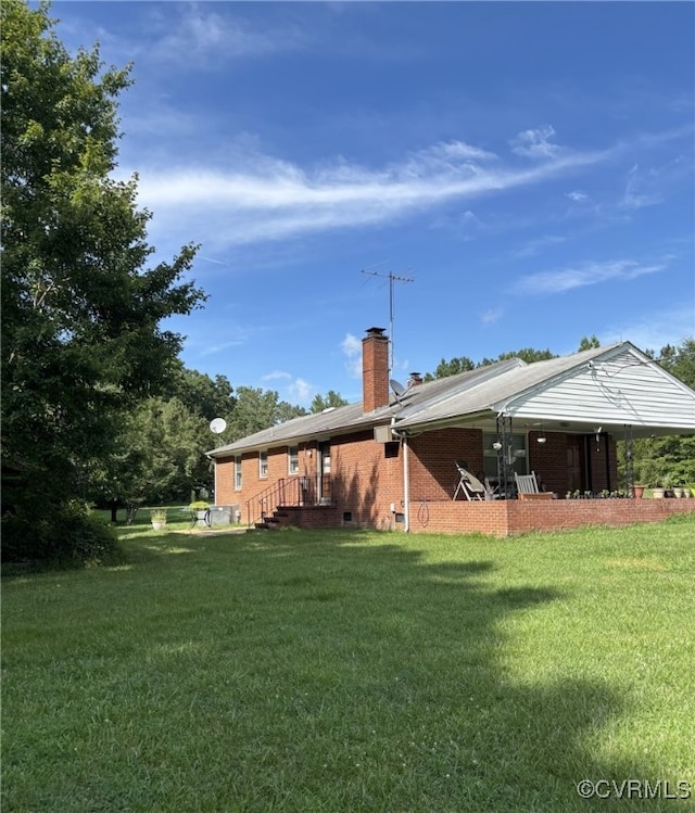 3246 Tabscott Rd, Goochland, VA 23038 - back of house with a chimney, brick siding, and a yard