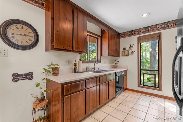 10000 Silverleaf Ter, Chesterfield, VA 23236 - kitchen featuring black dishwasher, light countertops, light tile patterned floors, fridge, and brown cabinetry