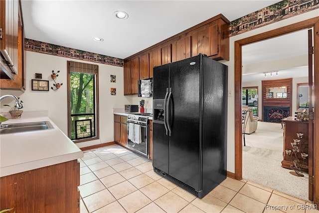10000 Silverleaf Ter, Chesterfield, VA 23236 - kitchen with black fridge, range with electric cooktop, light tile patterned floors, light countertops, and brown cabinetry