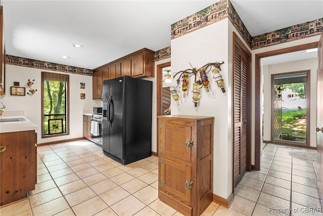 10000 Silverleaf Ter, Chesterfield, VA 23236 - kitchen featuring black refrigerator with ice dispenser, light tile patterned flooring, light countertops, range, and recessed lighting