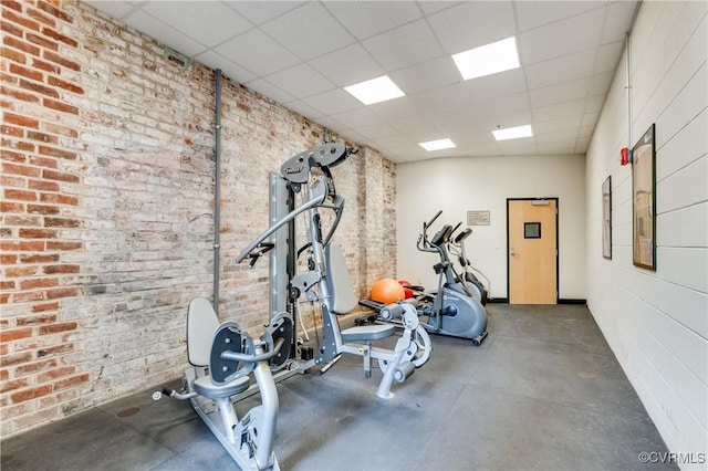 110 W Marshall St Unit U25, Richmond, VA 23220 - workout room featuring a drop ceiling and brick wall