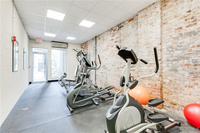 110 W Marshall St Unit U25, Richmond, VA 23220 - workout area featuring a drop ceiling and brick wall