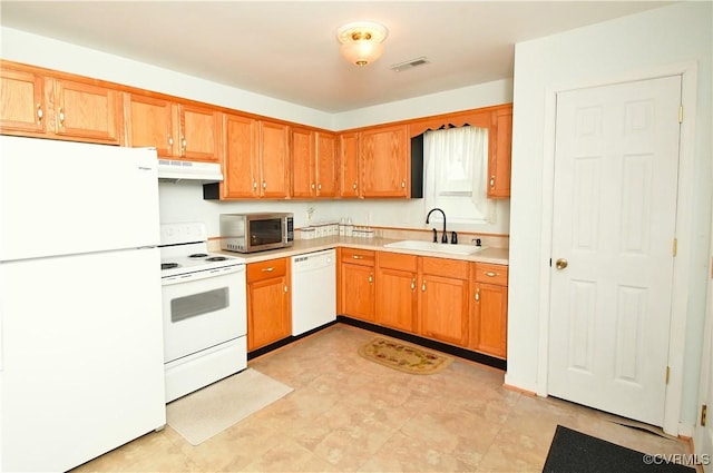 10106 Redbridge Rd, North Chesterfield, VA 23236 - kitchen with white appliances, under cabinet range hood, light countertops, and brown cabinetry
